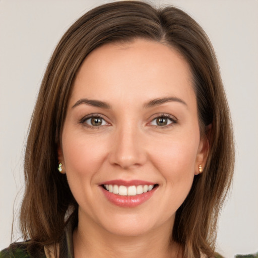 Joyful white young-adult female with long  brown hair and green eyes