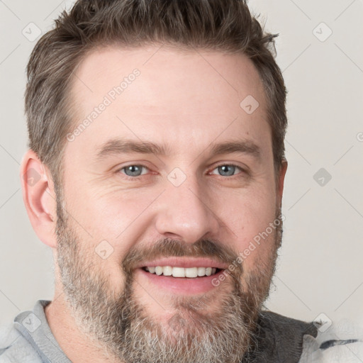 Joyful white adult male with short  brown hair and grey eyes