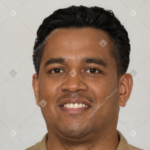 Joyful latino young-adult male with short  brown hair and brown eyes