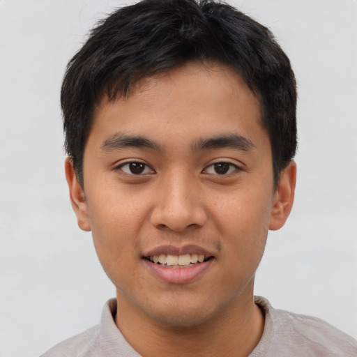 Joyful asian young-adult male with short  brown hair and brown eyes