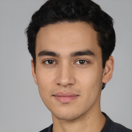 Joyful latino young-adult male with short  black hair and brown eyes