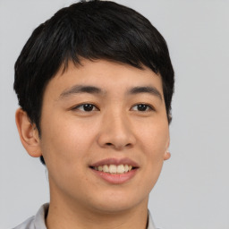 Joyful asian young-adult male with short  brown hair and brown eyes