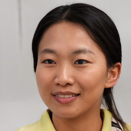 Joyful asian young-adult female with medium  brown hair and brown eyes