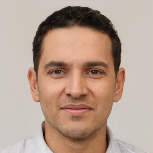 Joyful white adult male with short  brown hair and brown eyes