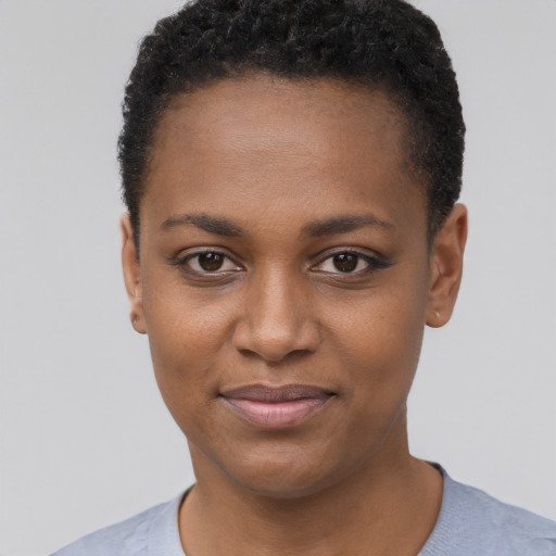 Joyful black young-adult female with short  black hair and brown eyes