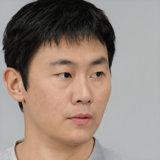 Neutral asian young-adult male with short  brown hair and brown eyes