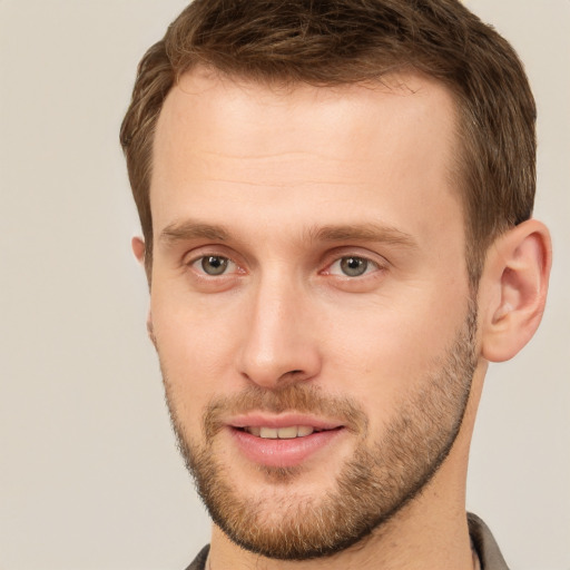 Joyful white young-adult male with short  brown hair and grey eyes