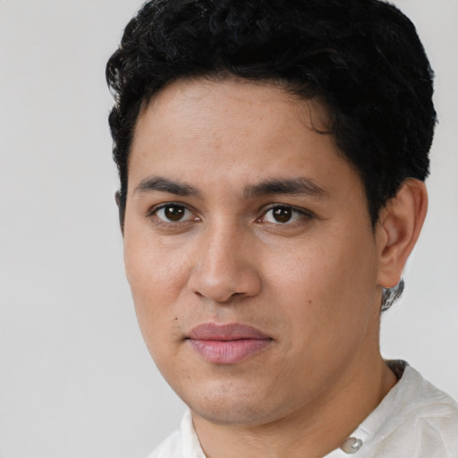 Joyful latino young-adult male with short  black hair and brown eyes