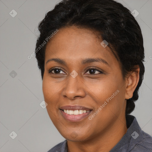 Joyful black young-adult female with short  brown hair and brown eyes