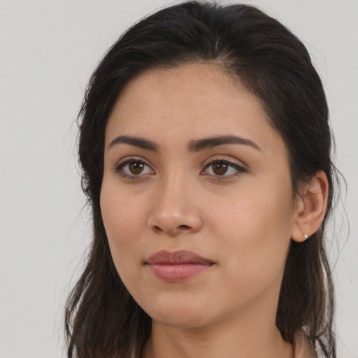 Joyful asian young-adult female with long  brown hair and brown eyes