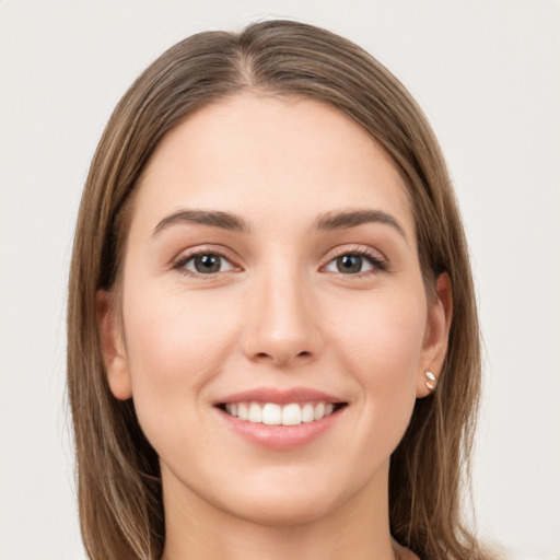 Joyful white young-adult female with long  brown hair and grey eyes