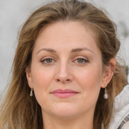 Joyful white young-adult female with long  brown hair and blue eyes