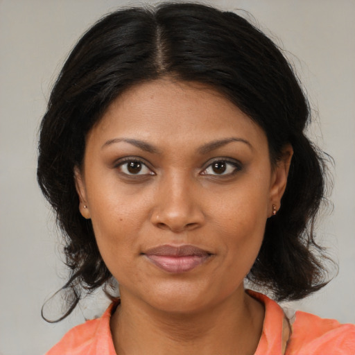 Joyful black young-adult female with medium  brown hair and brown eyes