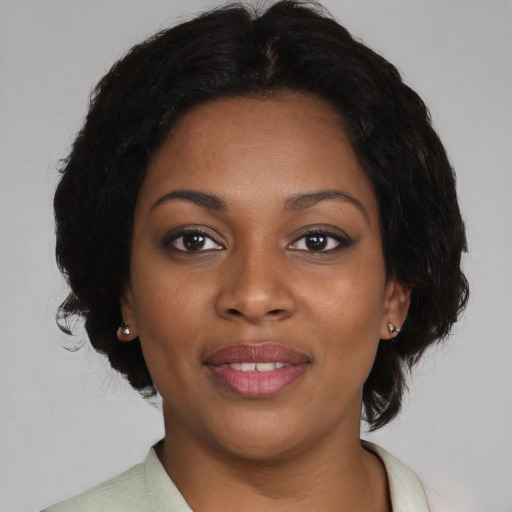 Joyful black young-adult female with medium  black hair and brown eyes
