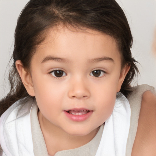 Joyful white child female with medium  brown hair and brown eyes