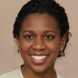 Joyful black adult female with short  brown hair and brown eyes