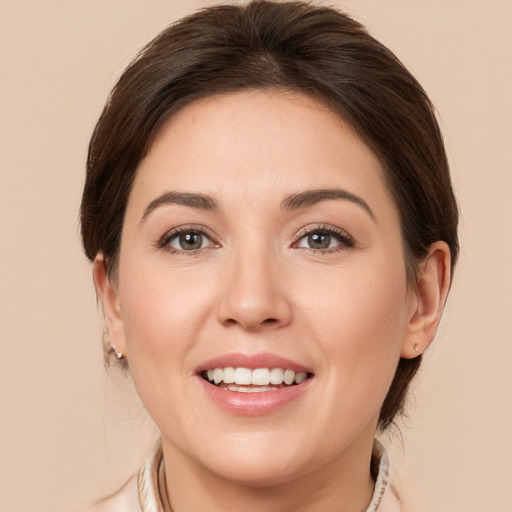 Joyful white young-adult female with medium  brown hair and brown eyes