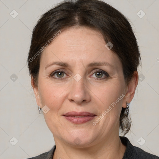 Joyful white adult female with medium  brown hair and grey eyes