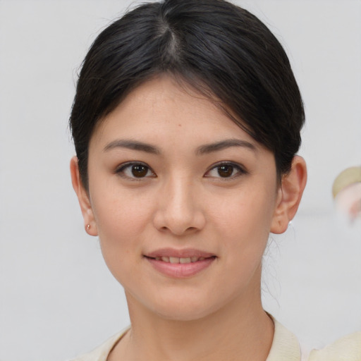 Joyful asian young-adult female with medium  brown hair and brown eyes