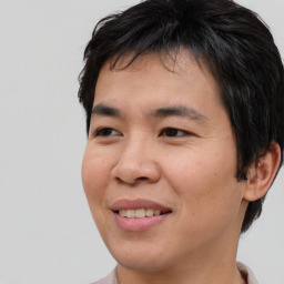 Joyful asian young-adult male with short  brown hair and brown eyes