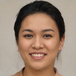 Joyful asian young-adult female with medium  brown hair and brown eyes