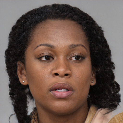Neutral black young-adult female with long  brown hair and brown eyes