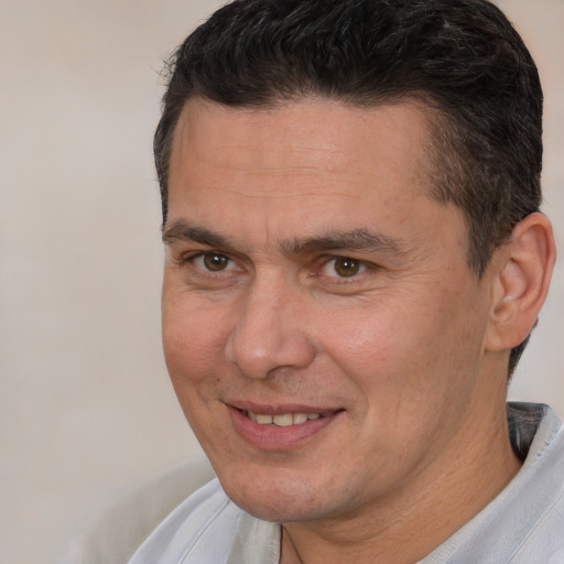 Joyful white adult male with short  brown hair and brown eyes