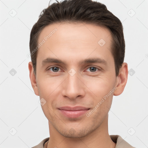 Joyful white young-adult male with short  brown hair and brown eyes