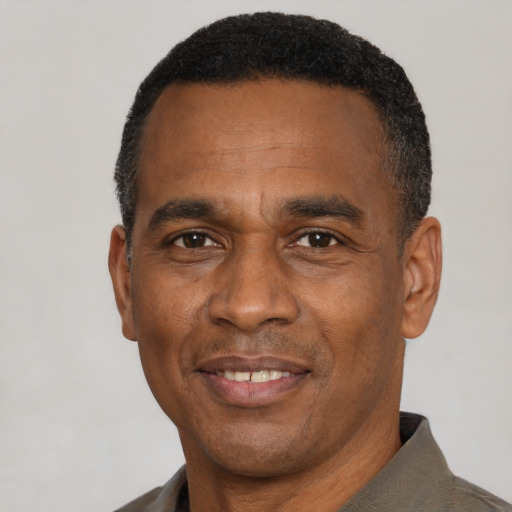 Joyful latino adult male with short  black hair and brown eyes