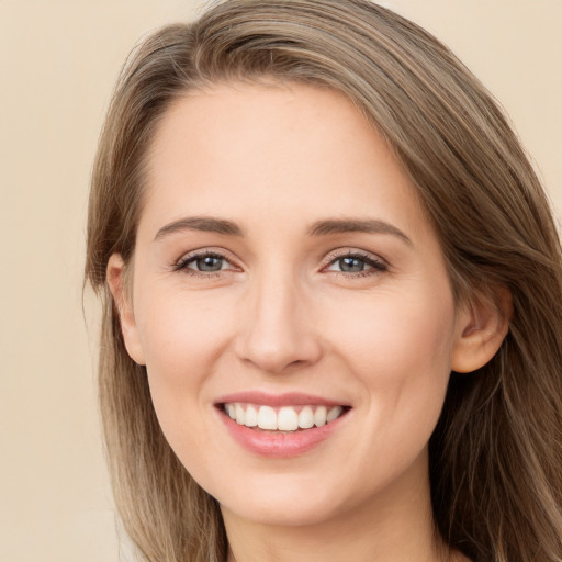 Joyful white young-adult female with long  brown hair and grey eyes