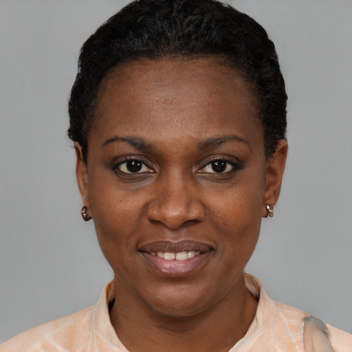 Joyful black young-adult female with short  black hair and brown eyes