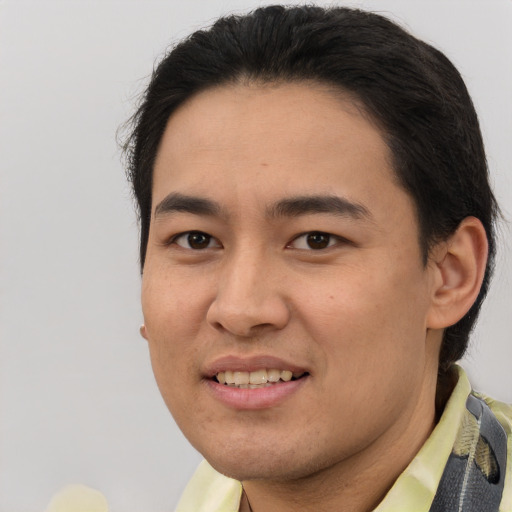 Joyful latino young-adult male with short  brown hair and brown eyes