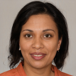 Joyful white adult female with medium  brown hair and brown eyes