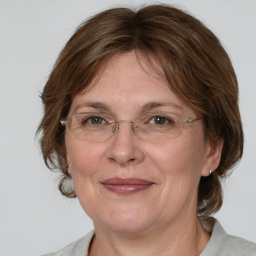 Joyful white adult female with medium  brown hair and blue eyes