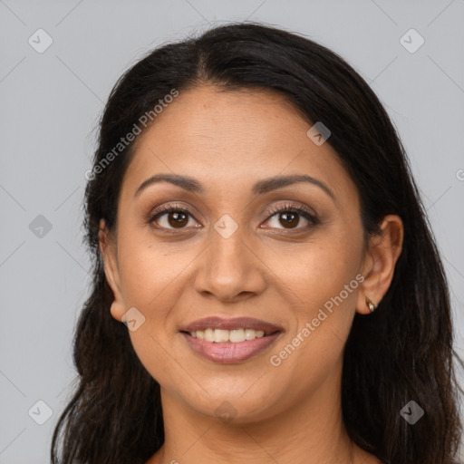 Joyful latino adult female with long  brown hair and brown eyes