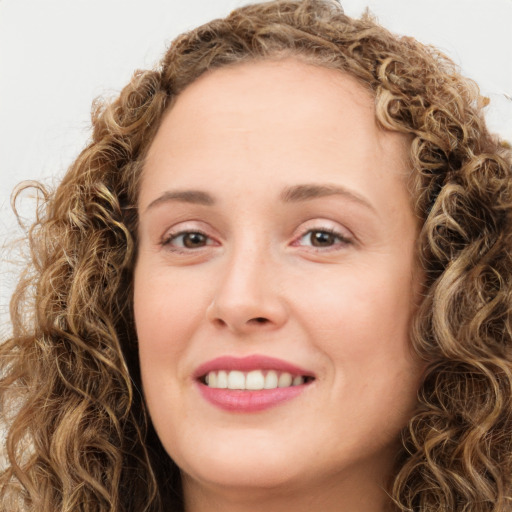 Joyful white young-adult female with long  brown hair and green eyes