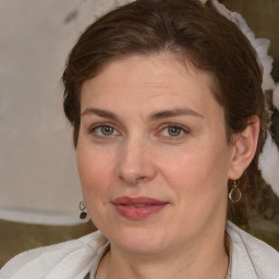 Joyful white adult female with medium  brown hair and brown eyes