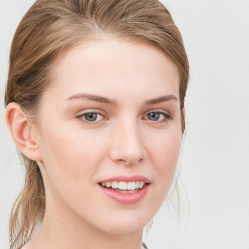 Joyful white young-adult female with medium  brown hair and blue eyes