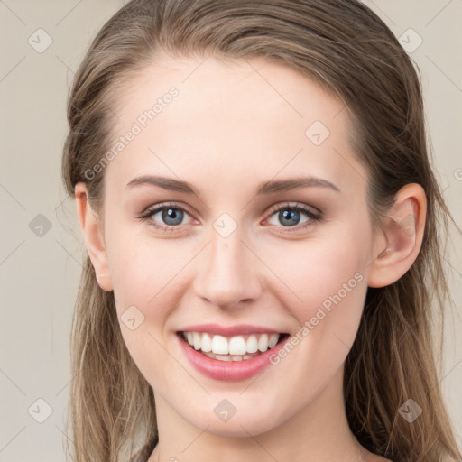 Joyful white young-adult female with long  brown hair and grey eyes