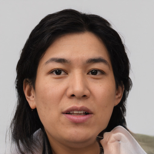 Joyful asian young-adult female with medium  brown hair and brown eyes