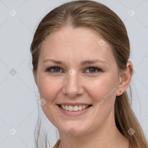 Joyful white young-adult female with long  brown hair and grey eyes