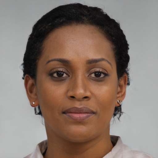 Joyful black young-adult female with short  brown hair and brown eyes