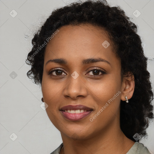 Joyful black young-adult female with long  brown hair and brown eyes