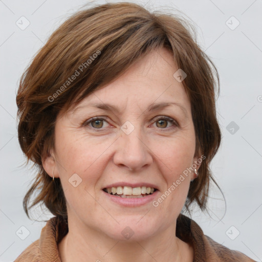 Joyful white adult female with medium  brown hair and grey eyes