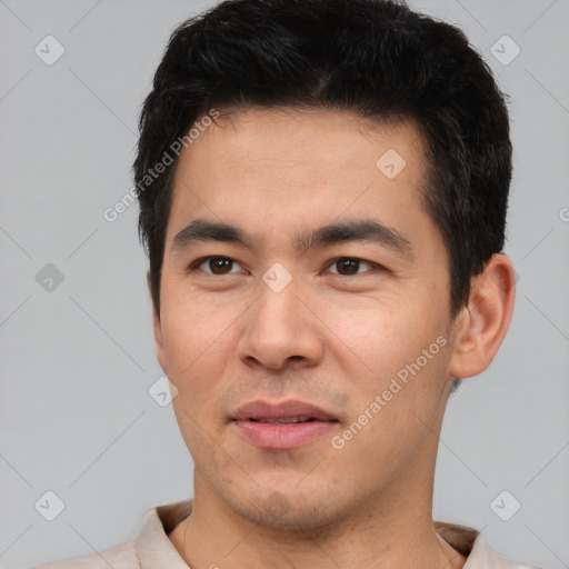 Joyful asian young-adult male with short  brown hair and brown eyes