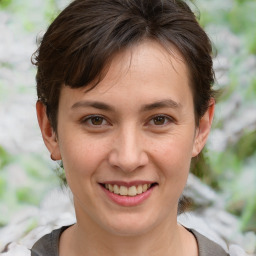 Joyful white young-adult female with medium  brown hair and brown eyes