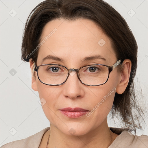 Joyful white adult female with medium  brown hair and grey eyes