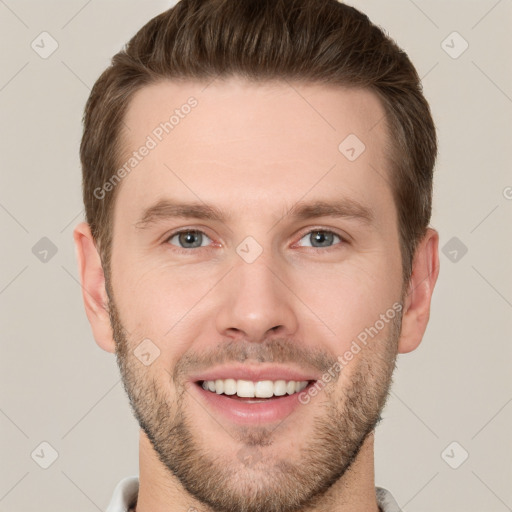 Joyful white young-adult male with short  brown hair and grey eyes