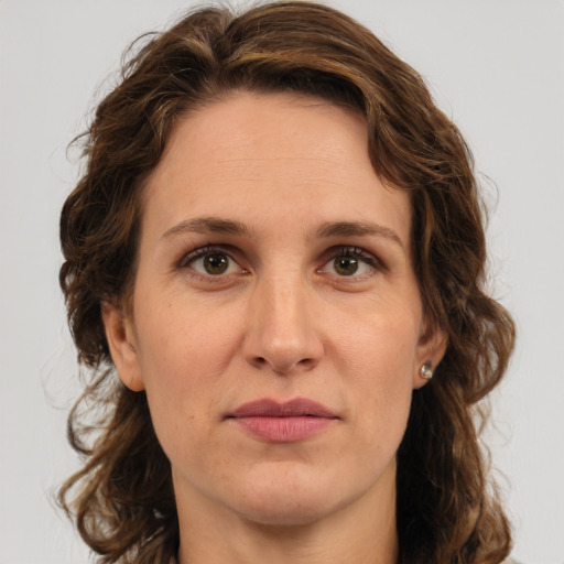 Joyful white adult female with medium  brown hair and green eyes