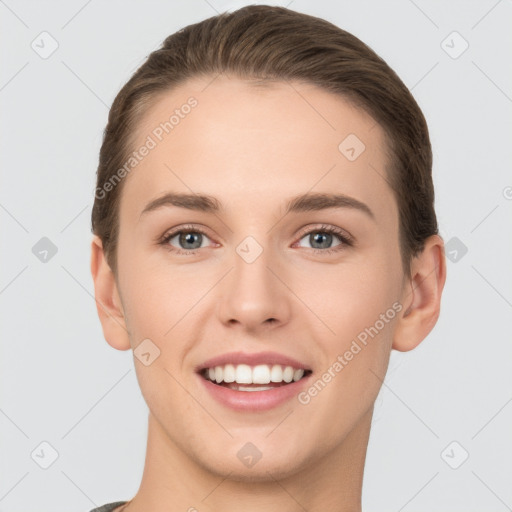 Joyful white young-adult female with short  brown hair and grey eyes